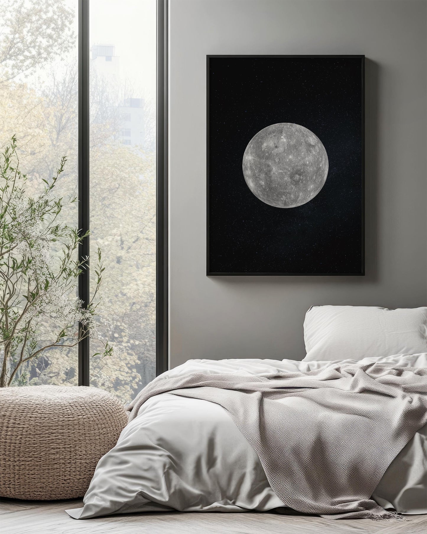 a serene bedroom scene with a large window overlooking a lush green tree outside. The window is framed by a black picture frame, which features a large, detailed image of the moon. The bed is covered in a white comforter and a gray throw blanket, creating a cozy and inviting atmosphere.