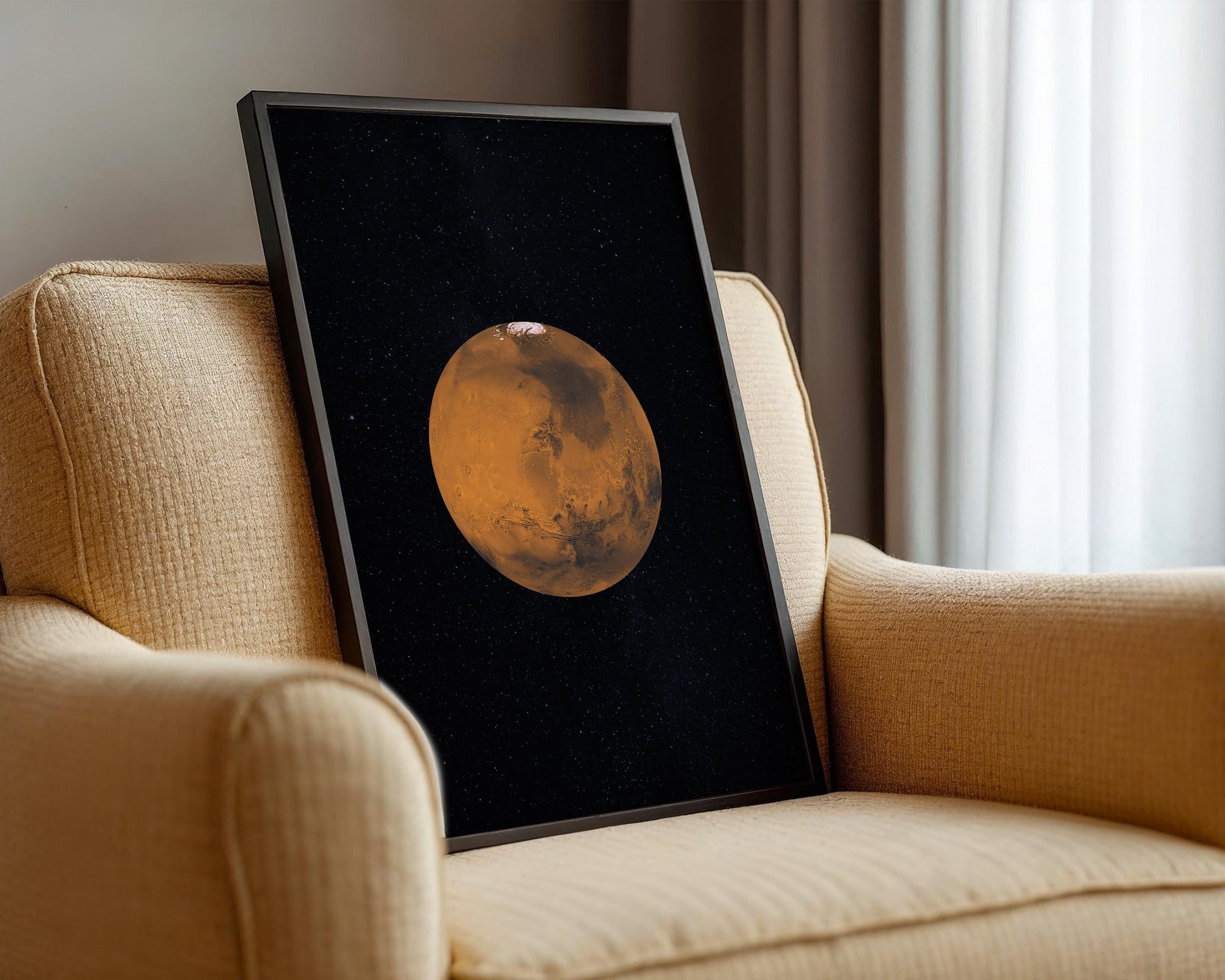 a framed picture of a planet, likely Mars, displayed on a beige armchair.