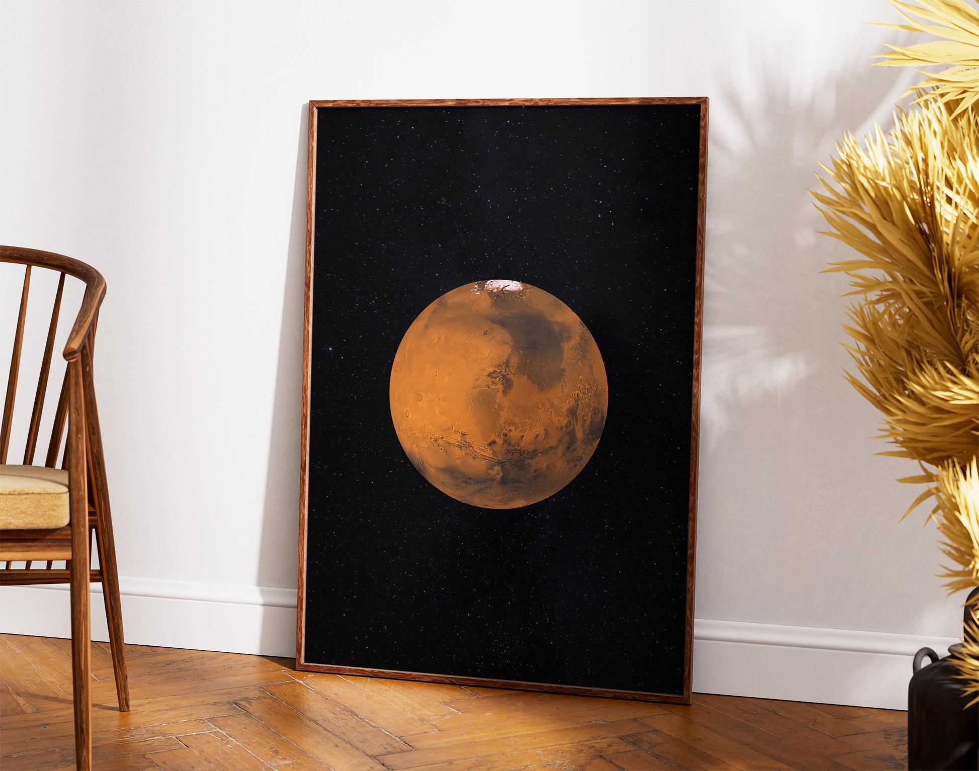 a large framed picture of a planet, likely Mars, set against a black background with a starry sky.