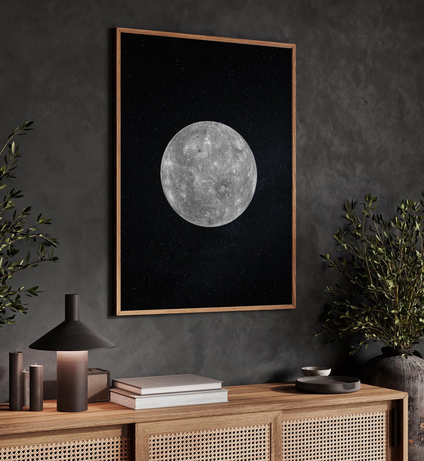 a wooden cabinet with a lamp, a framed picture of a moon, and a plant on a shelf.