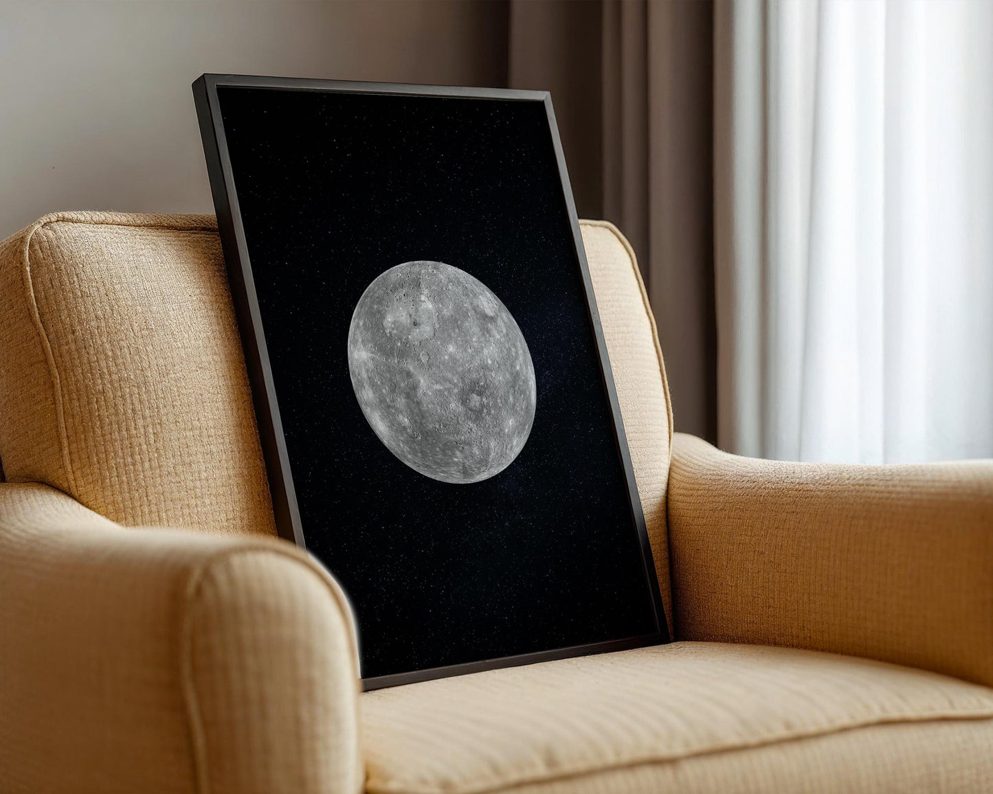 a framed picture of a moon on a chair.